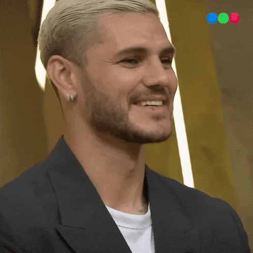 a man with blonde hair and a beard wearing earrings