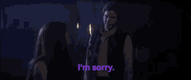 a man and a woman are standing next to each other and the woman says i 'm sorry