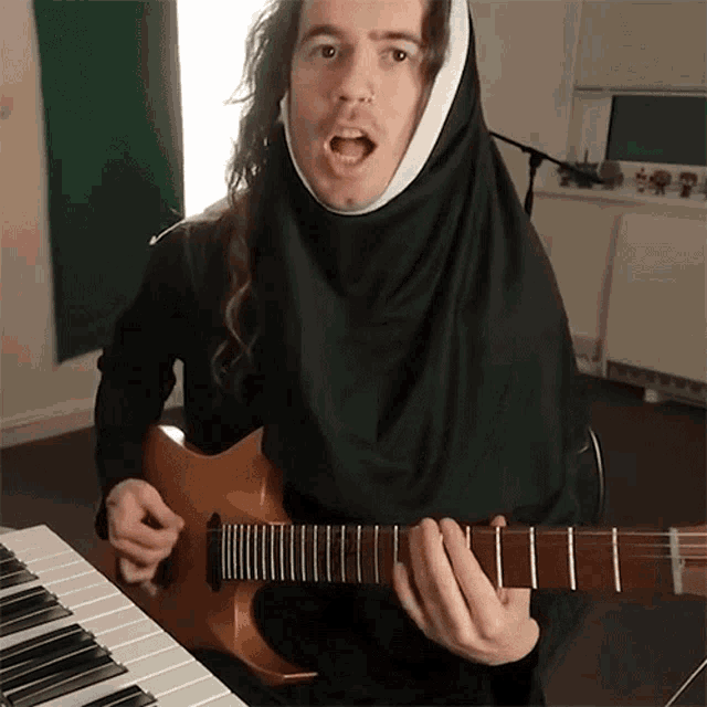 a man dressed as a nun is playing a guitar