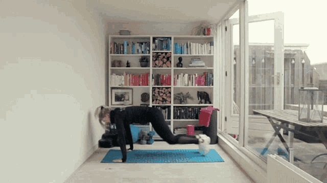 a woman is doing push ups on a yoga mat
