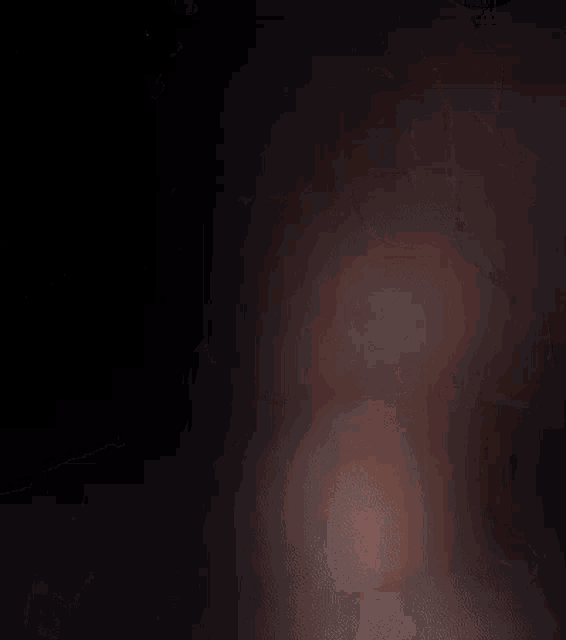 a blurred image of a person 's face with a dark background