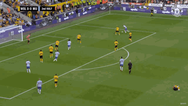 a soccer game is being played in front of an apollo ad