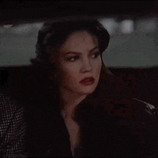 a woman with red lipstick is sitting in a car with a man
