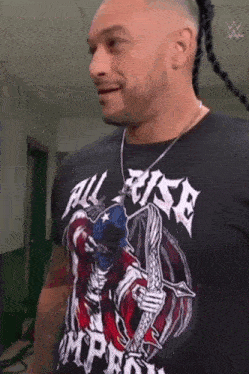 a man wearing a black t-shirt with a skeleton on it .