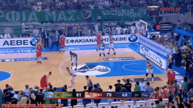 a basketball game is being played on a court with a banner for aebe