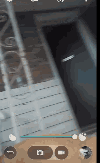a phone screen shows a picture of a door and a camera icon