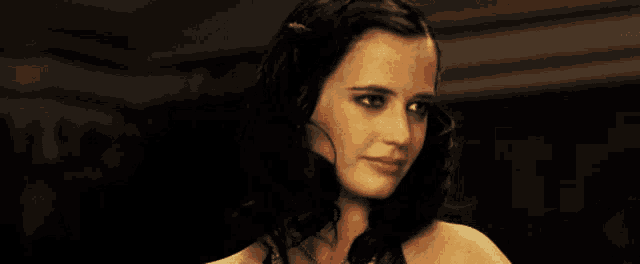 a close up of a woman 's face with a dark background