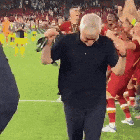 a man in a black shirt is dancing on a field