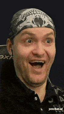 a man wearing a bandana with a skull on it is smiling with his mouth open .