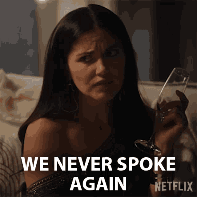 a woman holding a glass with the words we never spoke again behind her