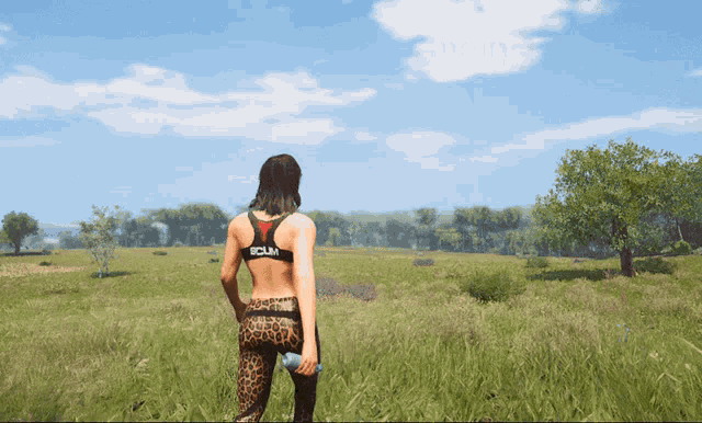 a woman standing in a field wearing a sports bra that says " scul " on it