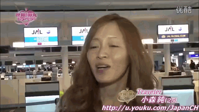 a woman in front of a jal sign