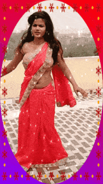 a woman in a red saree is dancing on a patio