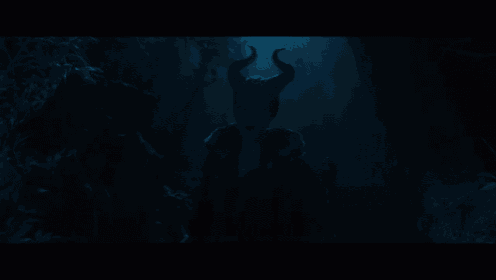 a woman with horns is standing in a dark cave