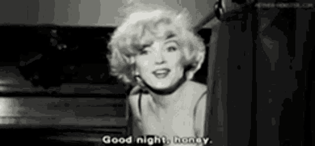 a black and white photo of a woman saying `` good night , honey . ''