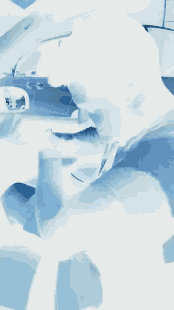 a blurry picture of a man in a car with a blue background