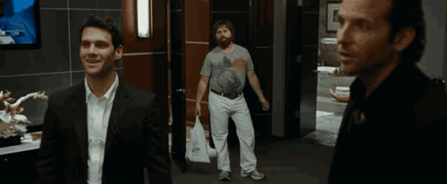 a man in a suit says " hey guys you ready to let the dogs out " to another man