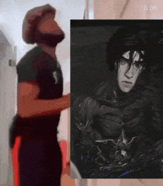 a man is standing next to a painting of a man with a beard and the time is 0:06