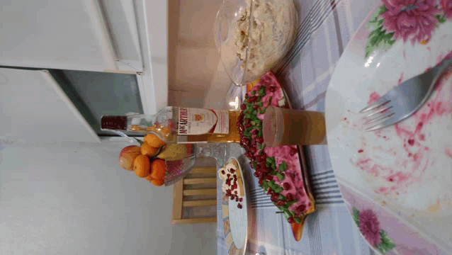 a bottle of mcarthur sits on a table next to a plate of food