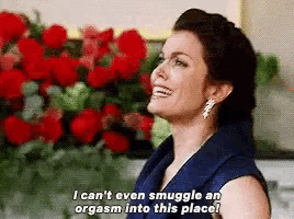 a woman in a blue dress is smiling and saying i can 't even snuggle an orgasm into this place .