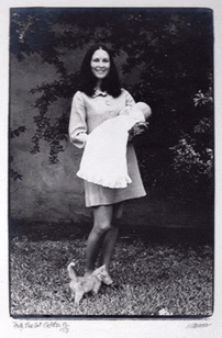 a black and white photo of a woman holding a baby and a dog with a watermark that says ' all the best '