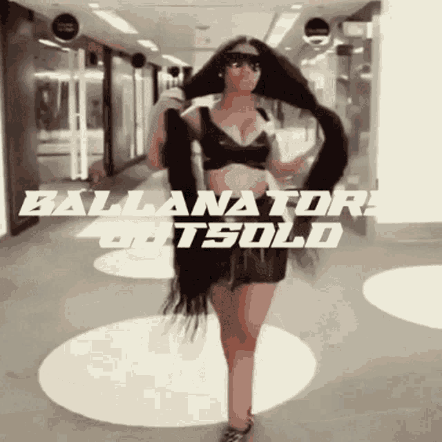 a woman with very long hair is standing in a hallway with the words " ballanators outsold " written above her
