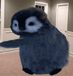 a stuffed penguin is standing in a room