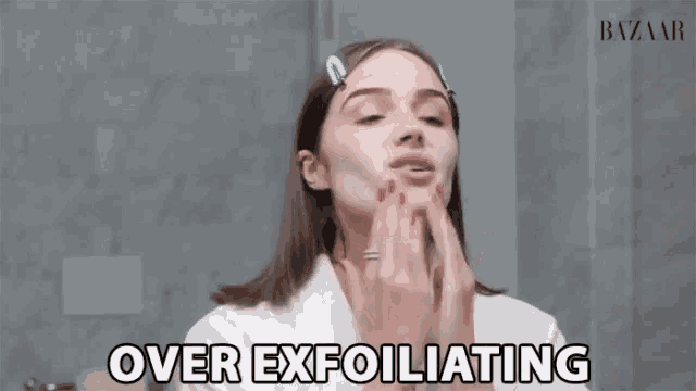 a woman is exfoliating her face in front of a mirror