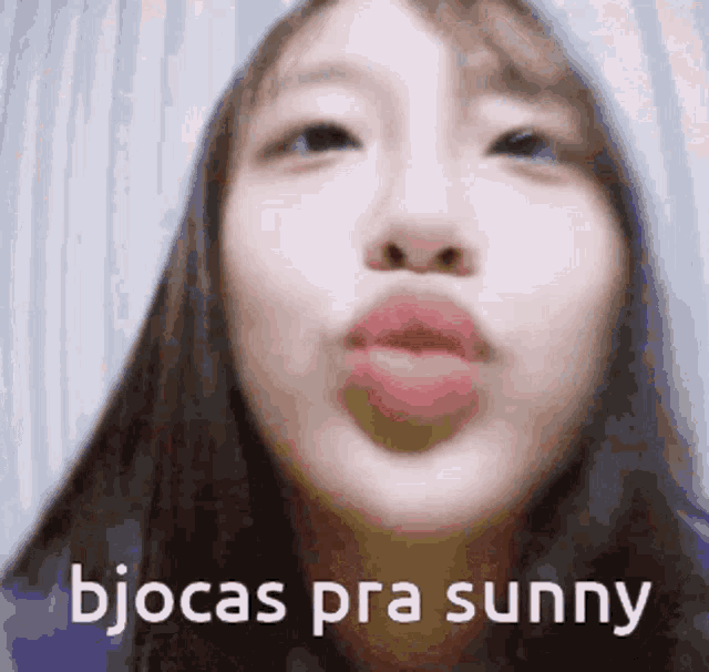 a close up of a woman 's face with the words bjocas pra sunny written above her