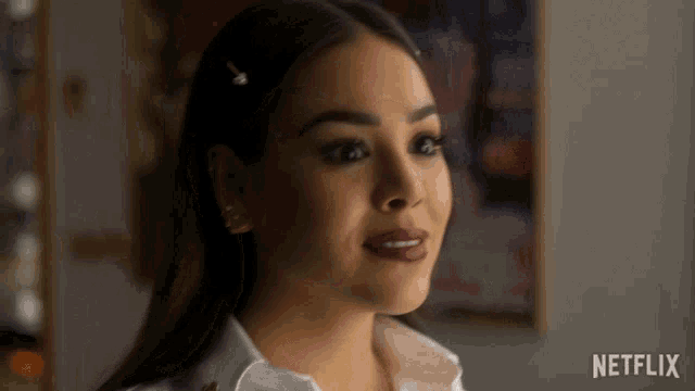 a close up of a woman 's face with a netflix logo in the background