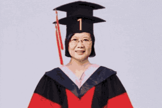 a woman wearing a graduation cap and gown has the number 1 on it