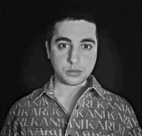 a man is wearing a shirt that says " rlkanik " on it