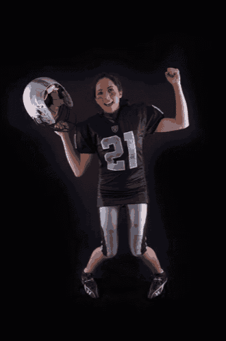 a woman in a football uniform with the number 21 on her jersey
