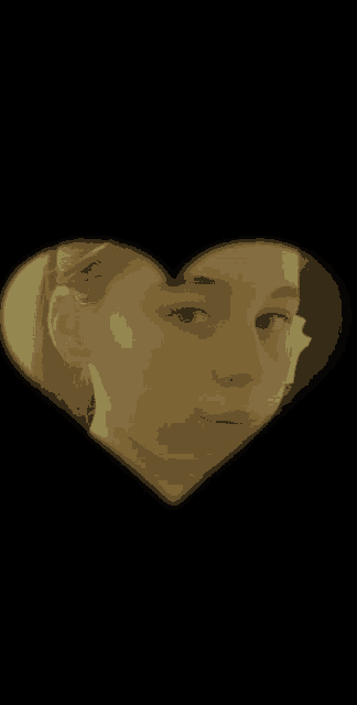 a close up of a girl 's face in a heart shaped hole