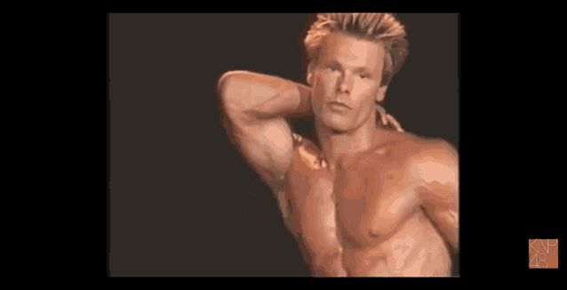 a man without a shirt is standing in front of a black background with an x on it