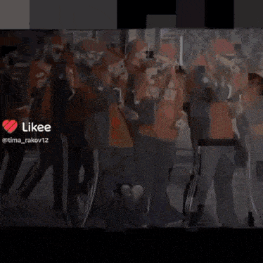 a group of people are standing in a line with a likee icon in the corner