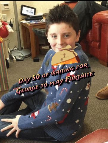 a boy wearing a sweater that says day 50 of waiting for george to play fortnite is sitting on the floor