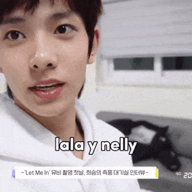 a close up of a person 's face with lala y nelly written on the bottom