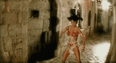 a woman is dancing in a narrow alleyway .