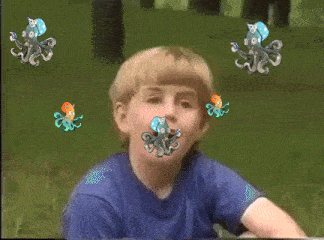 a boy in a blue shirt is smiling while octopus are flying around his head