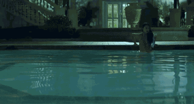 a close up of a woman 's face in a pool of water .
