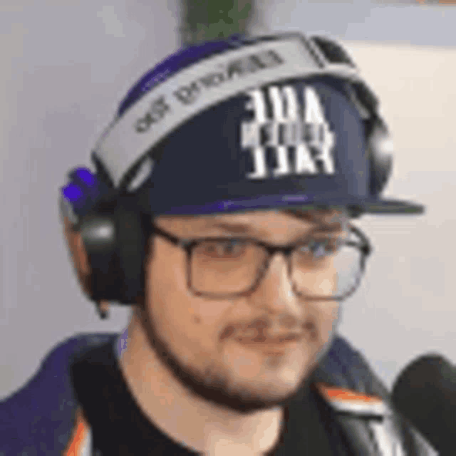 a man wearing glasses , headphones , a hat and a headband .