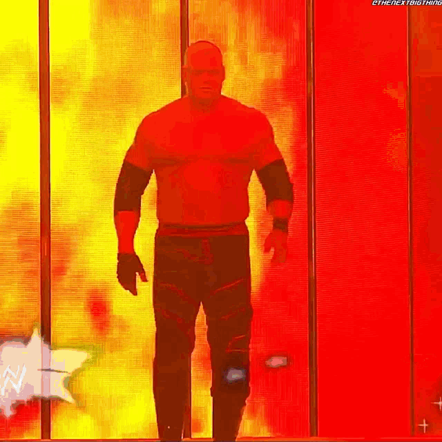 a shirtless wrestler is walking through a tunnel with a star in the background