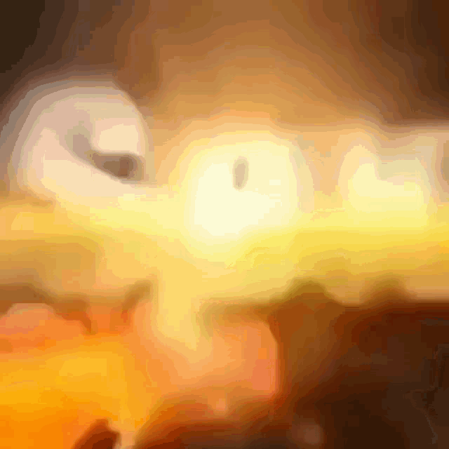 a blurry picture of a person 's face with a yellow light behind it