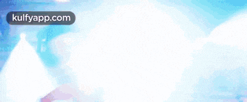 a man in a white shirt is smiling in front of a blue background with the words kulfyapp.com at the bottom