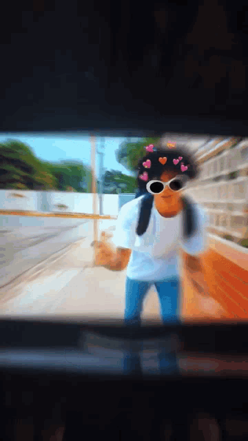 a blurry picture of a person wearing sunglasses and a crown of hearts