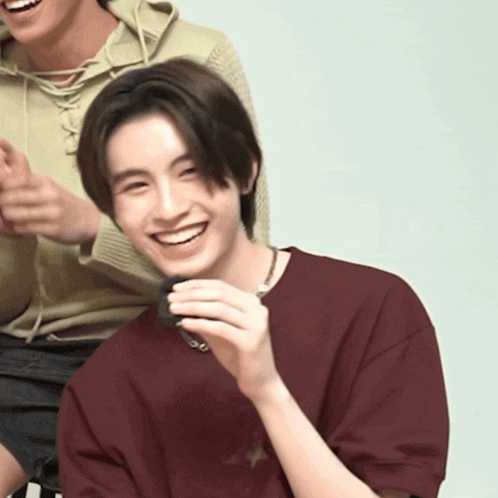 a man wearing a maroon shirt with a star on it