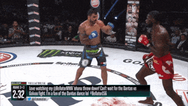 a boxing match is being shown on a television screen with the time of 2:32
