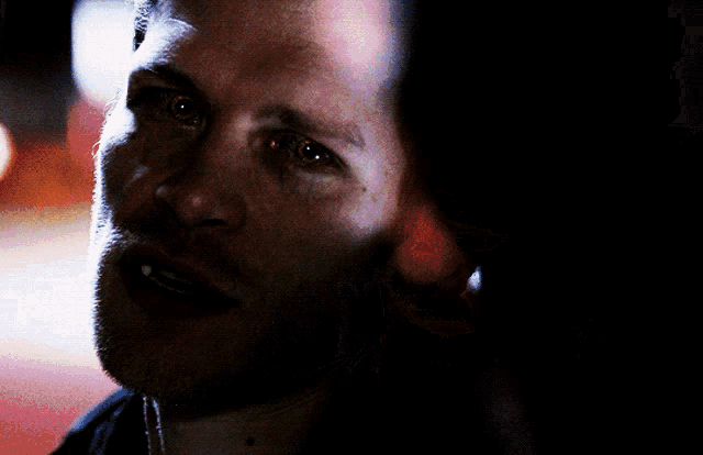 a close up of a man 's face with a tear running down his cheek