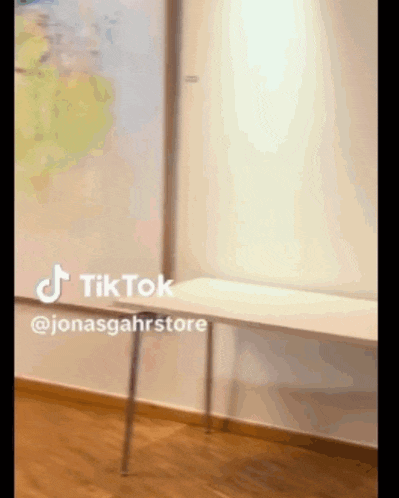 a tiktok video of a white bench with a map on the wall